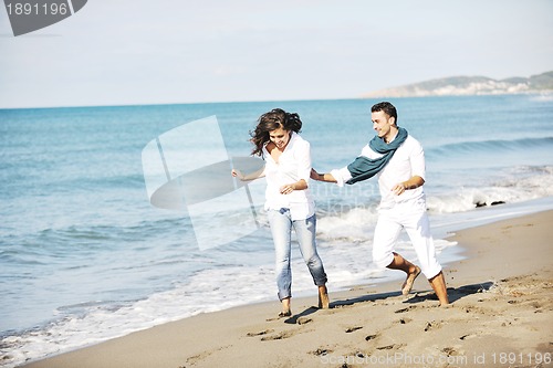 Image of happy young couple have fun at beautiful beach