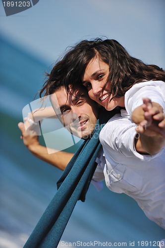 Image of happy young couple have fun at beautiful beach