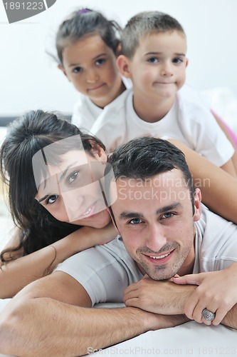 Image of happy young Family in their bedroom