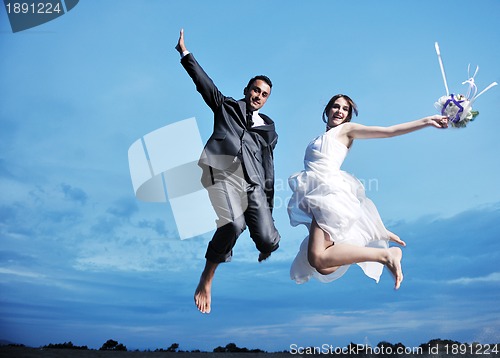 Image of romantic beach wedding at sunset