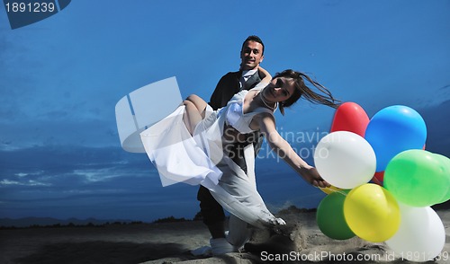 Image of romantic beach wedding at sunset