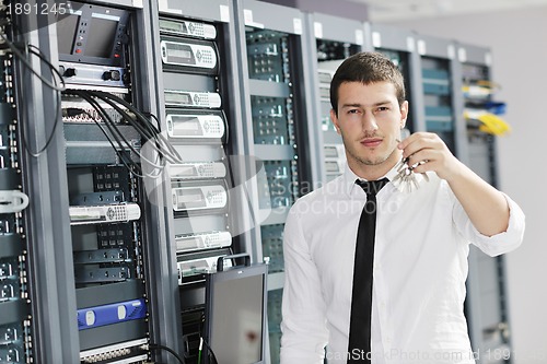 Image of young it engeneer in datacenter server room