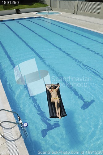 Image of woman relax on swimming pool