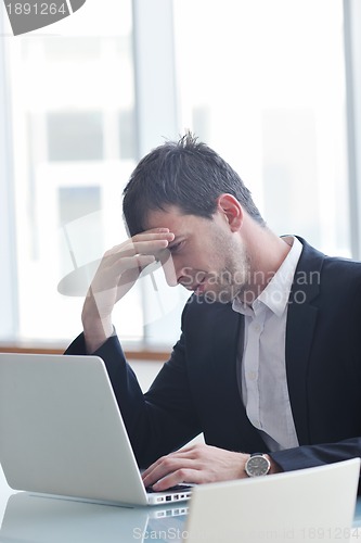 Image of young business man alone in conference room