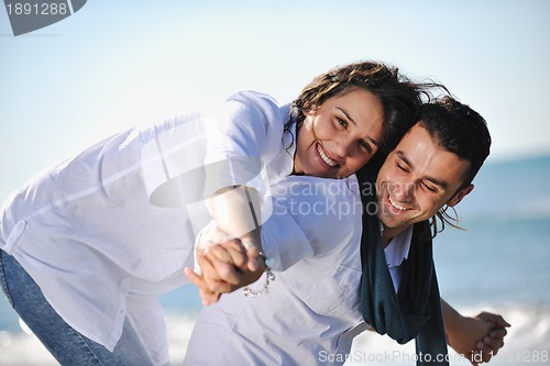 Image of happy young couple have fun at beautiful beach