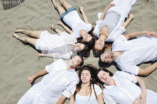 Image of Group of happy young people in have fun at beach