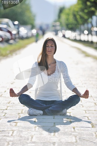 Image of yoga at sunny street