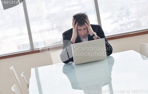 Image of young business man alone in conference room