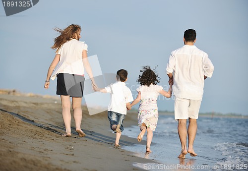 Image of happy young family have fun on beach