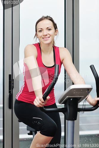 Image of woman workout  in fitness club on running track 