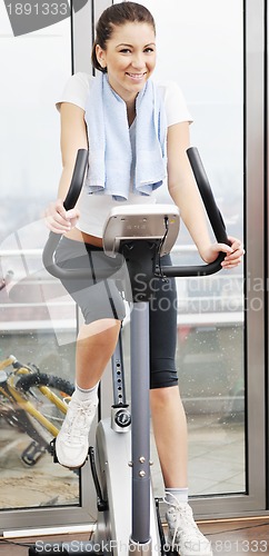 Image of woman workout  in fitness club on running track 