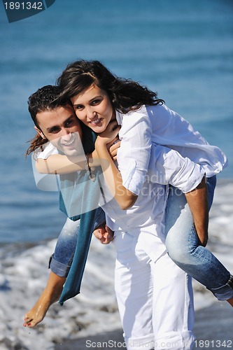 Image of happy young couple have fun at beautiful beach