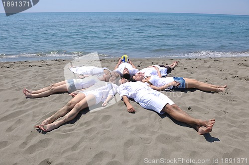Image of Group of happy young people in have fun at beach