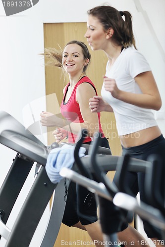 Image of woman workout  in fitness club on running track 