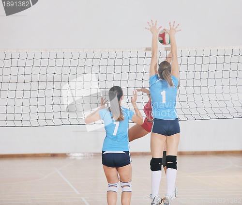 Image of girls playing volleyball indoor game