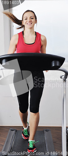 Image of woman workout  in fitness club on running track