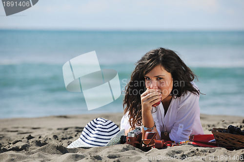 Image of happy young woman on beach