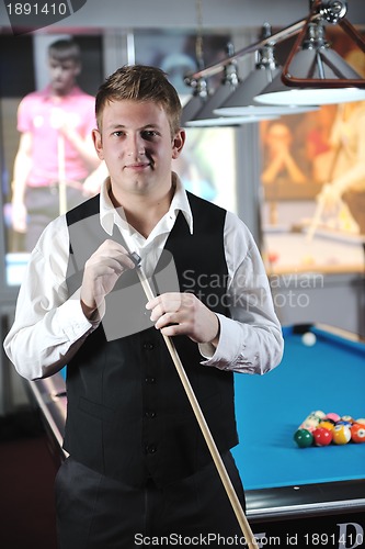 Image of young man play pro billiard game 