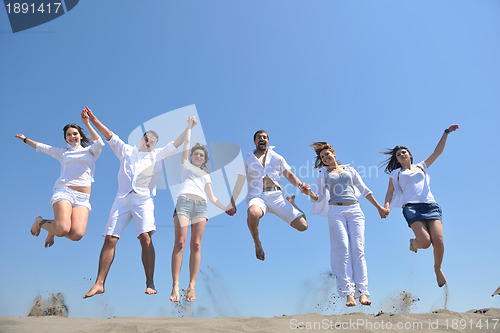 Image of happy people group have fun and running on beach