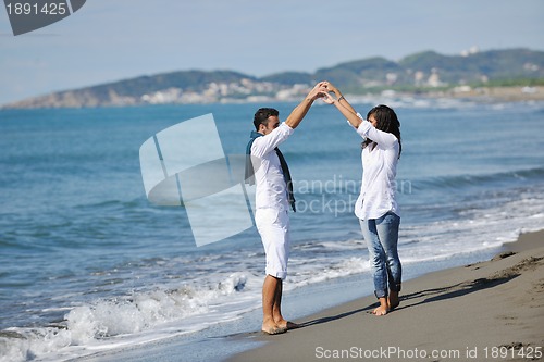 Image of happy young couple have fun at beautiful beach