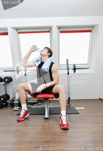 Image of man drink water at fitness workout 