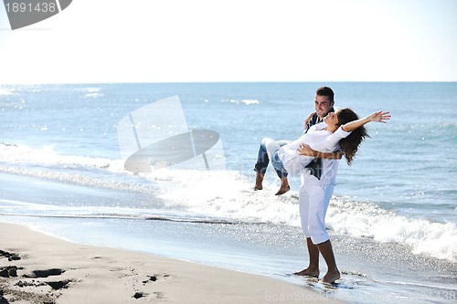 Image of happy young couple have fun at beautiful beach