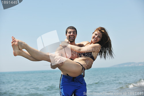 Image of happy young couple have fun on beach