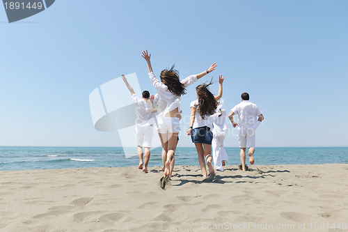 Image of happy people group have fun and running on beach