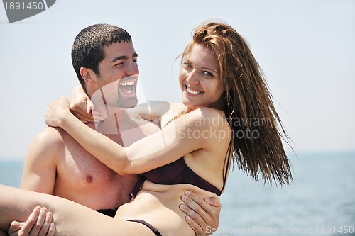 Image of happy young couple have fun on beach