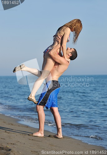 Image of happy young couple have romantic time on beach