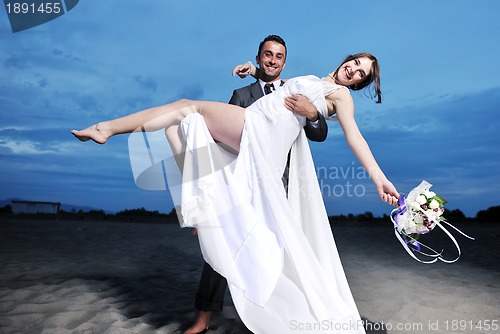 Image of romantic beach wedding at sunset