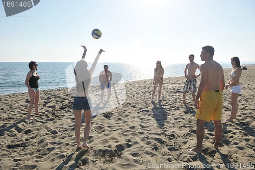 Image of young people group have fun and play beach volleyball