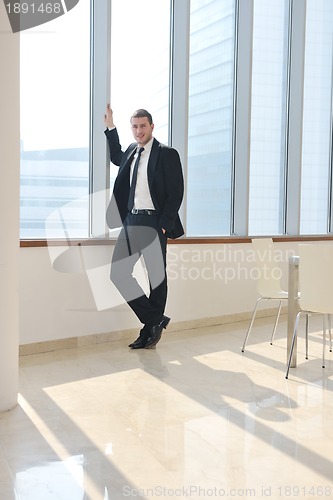 Image of young business man alone in conference room