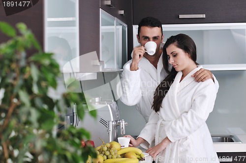 Image of Young love couple taking fresh morning cup of coffee