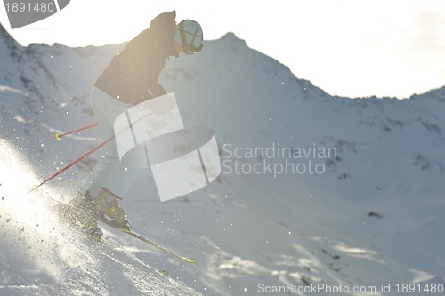 Image of woman skiing on fresh snow at winter season 