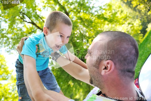 Image of happy father and son have fun at park