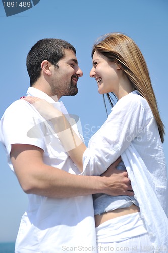 Image of happy young couple have fun on beach