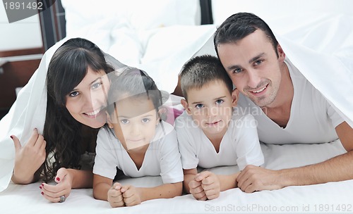 Image of happy young Family in their bedroom