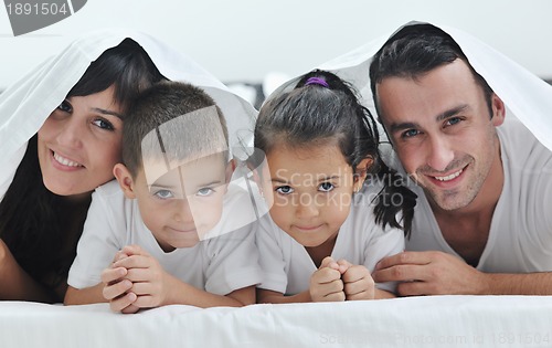Image of happy young Family in their bedroom