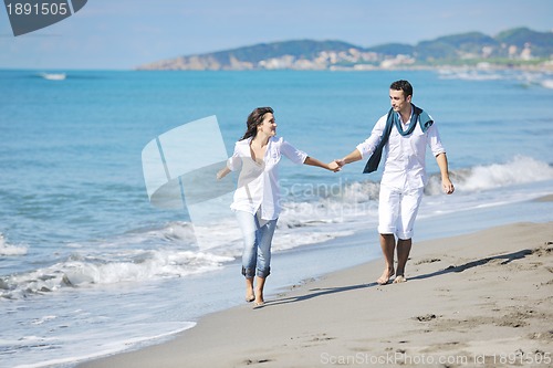 Image of happy young couple have fun at beautiful beach