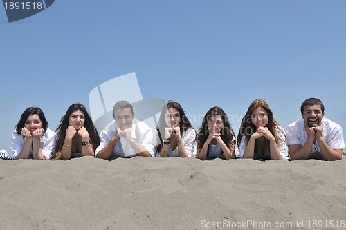 Image of Group of happy young people in have fun at beach