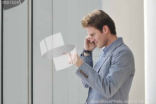 Image of young business man talk by cellphone