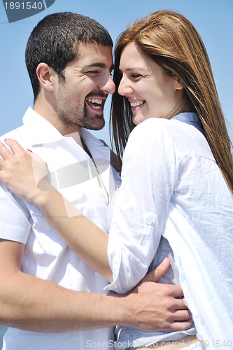 Image of happy young couple have fun on beach