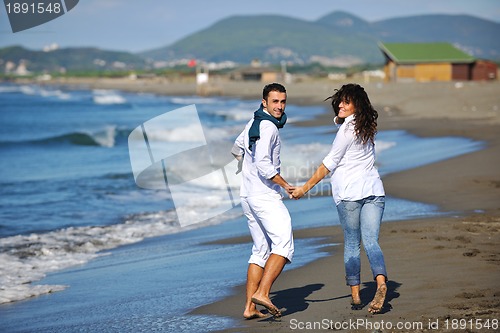 Image of happy young couple have fun at beautiful beach