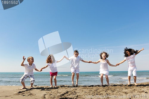 Image of happy child group playing  on beach