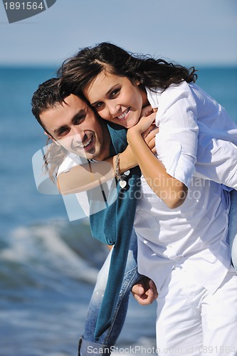 Image of happy young couple have fun at beautiful beach