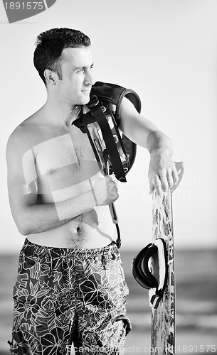Image of Portrait of a young  kitsurf  man at beach on sunset