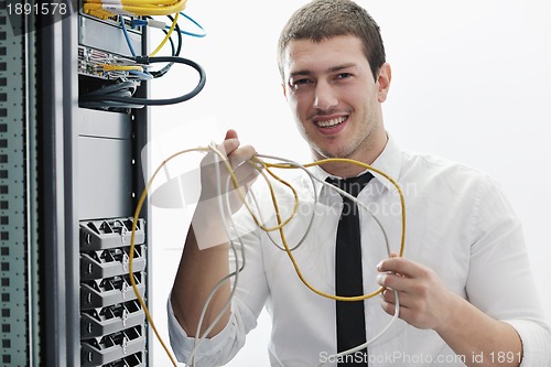 Image of young it engeneer in datacenter server room