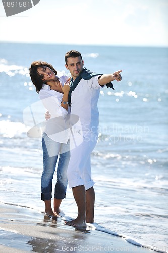Image of happy young couple have fun at beautiful beach