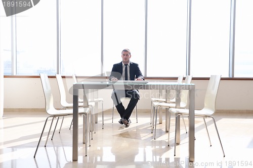 Image of  business man alone in conference room